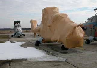 Military helicopter wrapped for storage